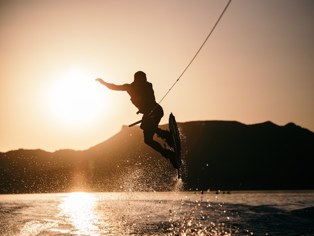 A wakeboarder carving across the wake behind a tow boat.