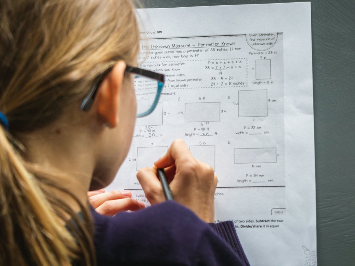 A student working through a maths worksheet.