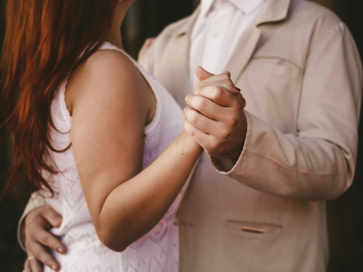 A couple in a close dance hold.